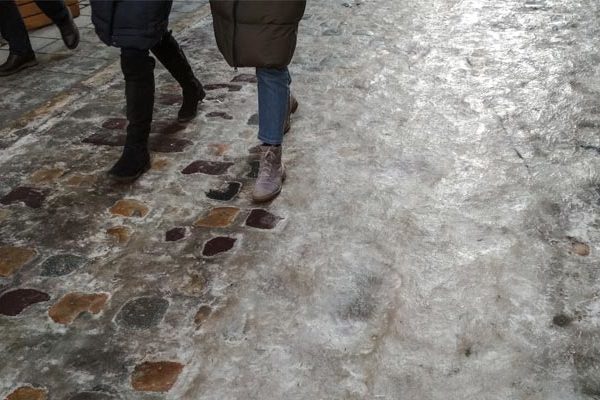 Slippery ground with two people walking