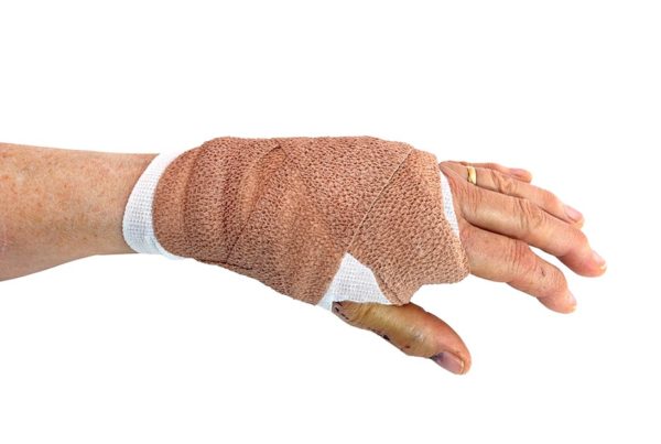 Bandaged female hand recovering from dog bite.